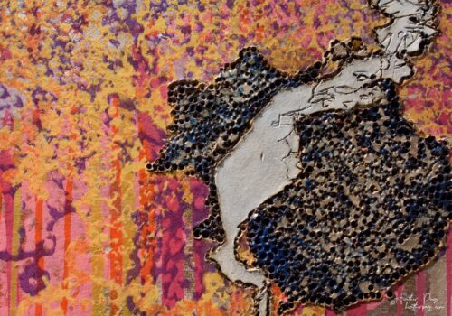 Detail of Les Amas Nuageux by Heather Page, an 11 7/8” by 17 1/8” x 2” monoprint on panel of brightly-colored woodburned, printed, & painted clouds of lichens