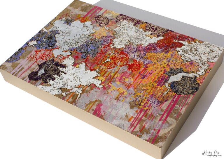 Les Amas Nuageux by Heather Page is an 11 7/8” by 17 1/8” x 2” monoprint on panel of woodburned, printed, and painted clouds of lichens in red, gold, and violet