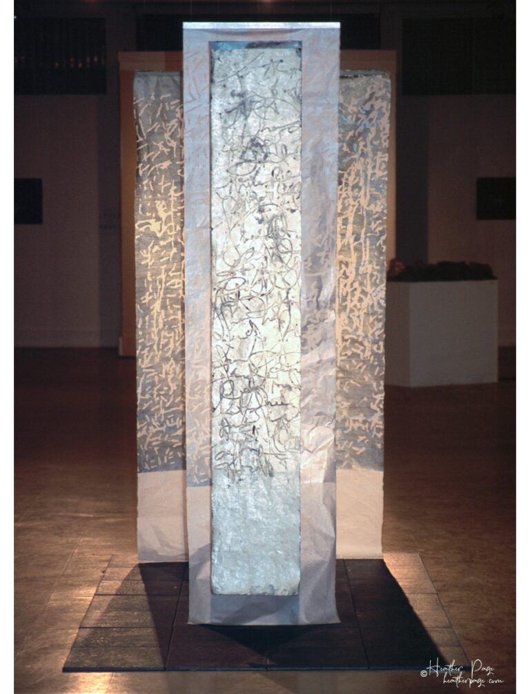 Reverb II by Heather Page, an art installation of large-scale prints on paper suspended from the ceiling of calligraphy, glyphs, and patterns found in nature